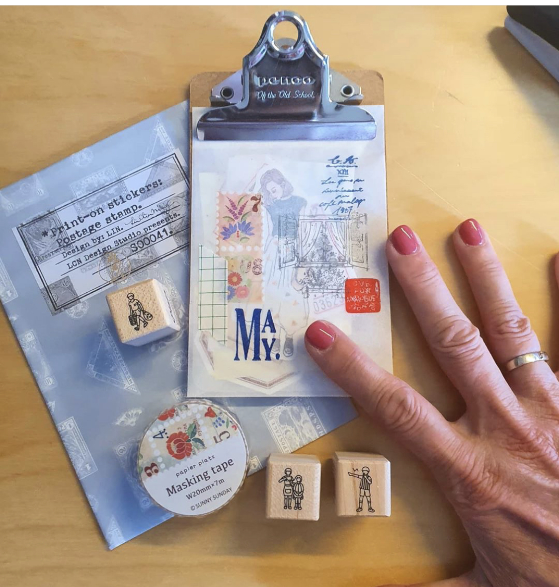 Clipboard, rubber stamps, washi tape, and ephemera